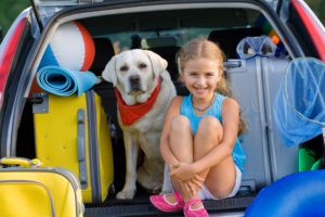 girl and dog on vacation
