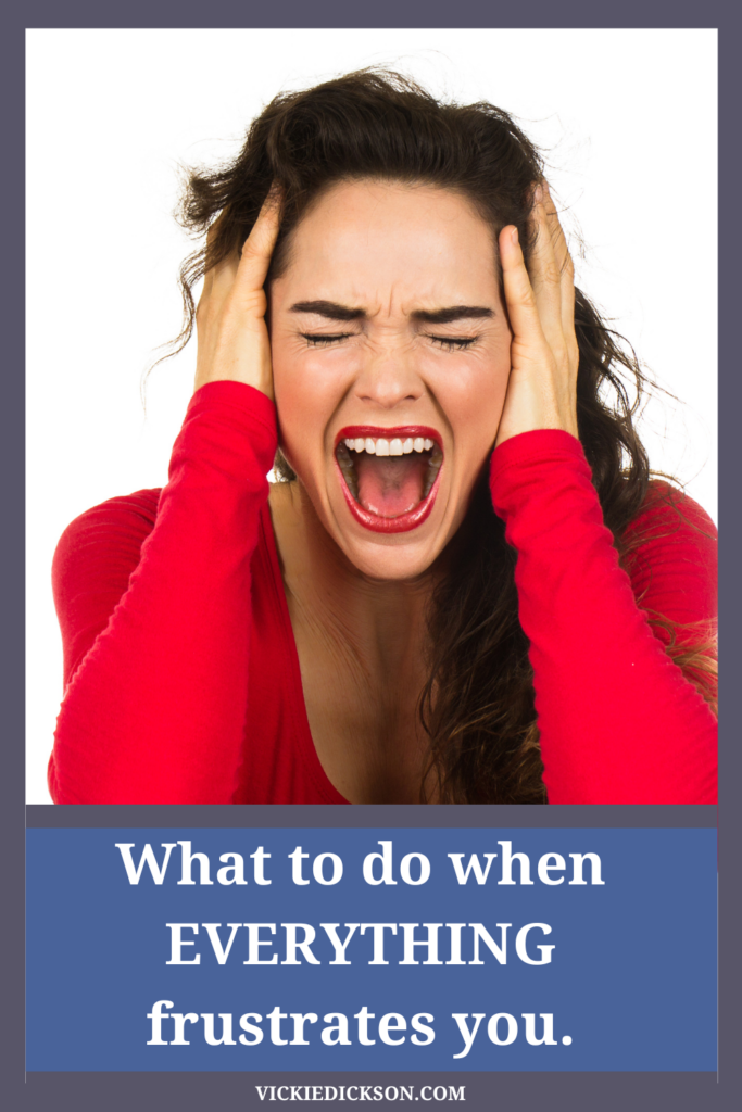 Frustrated woman in a red shirt with her hands on her head. What do do when everything frustrates you.  Manifesting Generator not self theme frustration